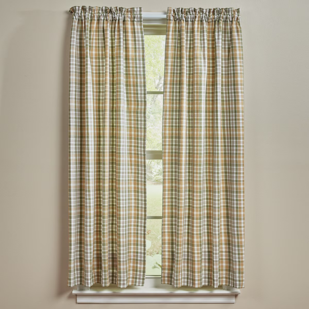 Plaid curtains on a window with a beige wall background