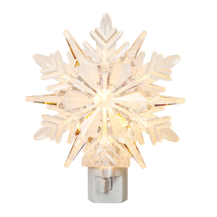A snowflake-shaped Christmas tree topper with a warm white LED light glowing from within, mounted on a silver metal base, isolated on a white background.