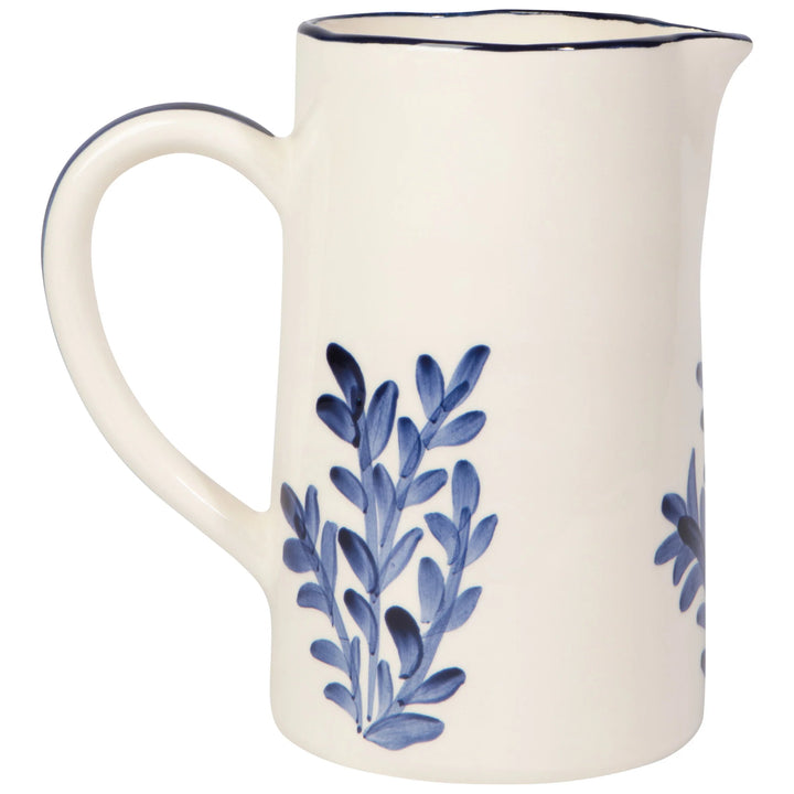 White ceramic pitcher with blue floral patterns on a white background