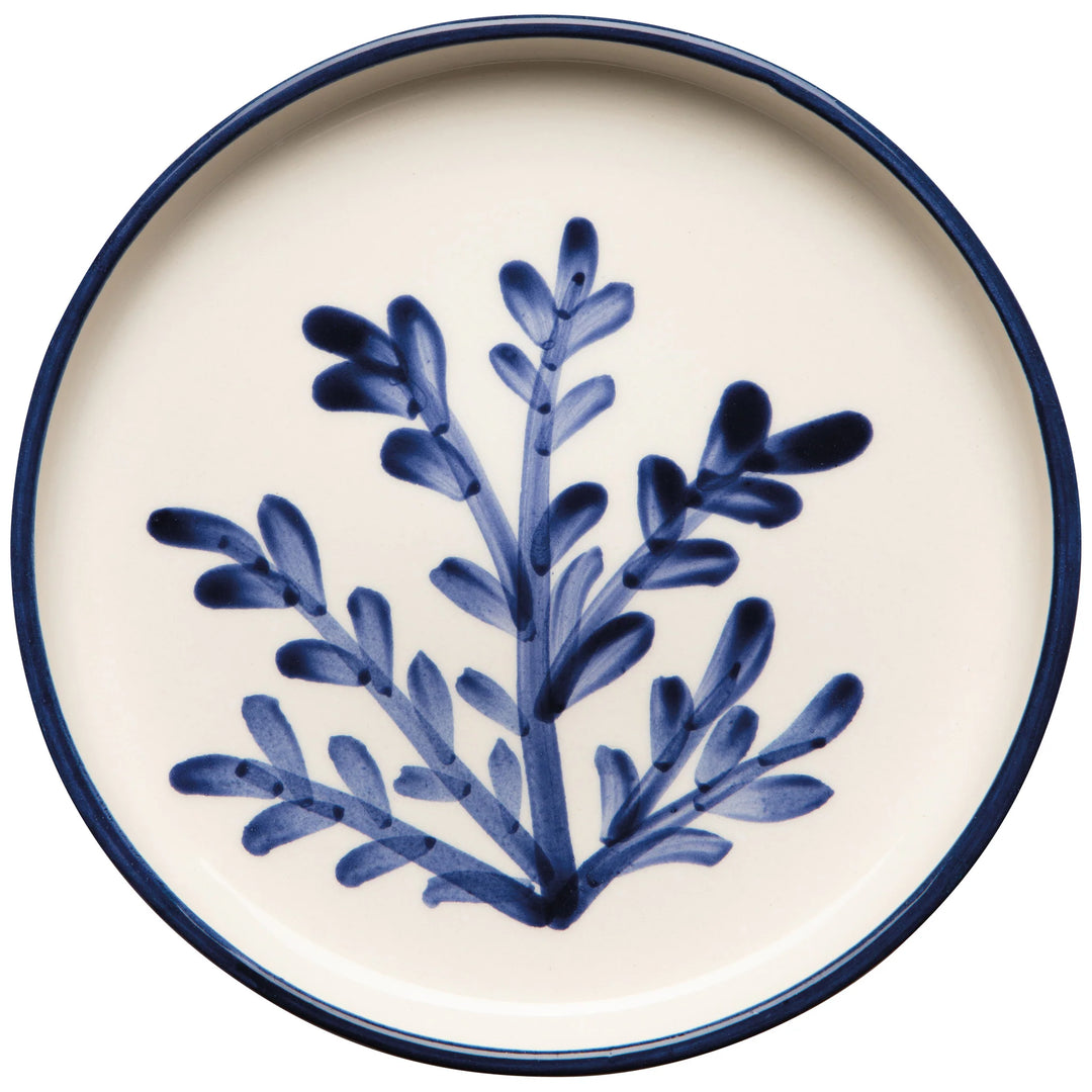 Ceramic plate with blue leaf design on a white background
