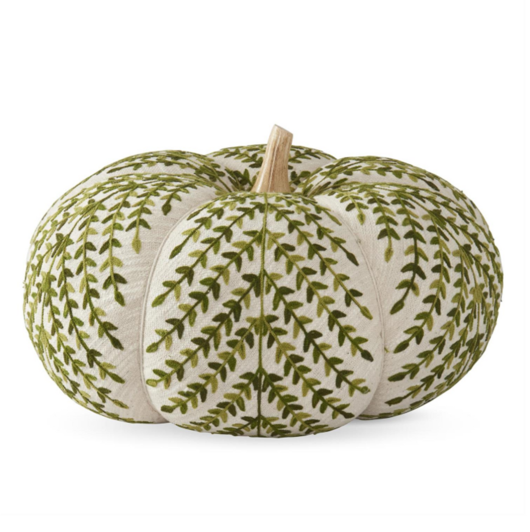 Decorative pumpkin with green leaf pattern on a white background