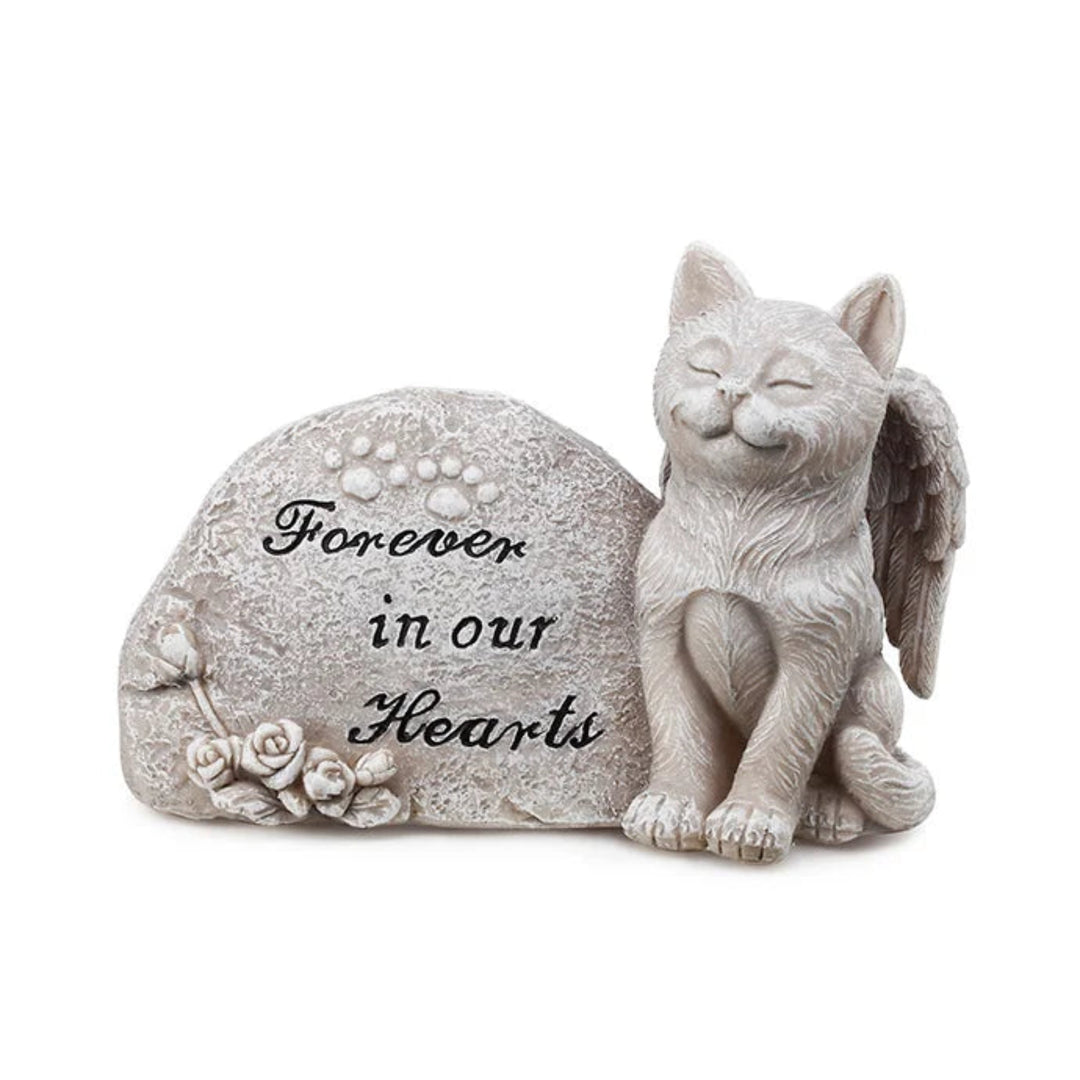 Memorial sculpture of a cat with angel wings and a stone, featuring the text 'Forever in our Hearts' on a white background.