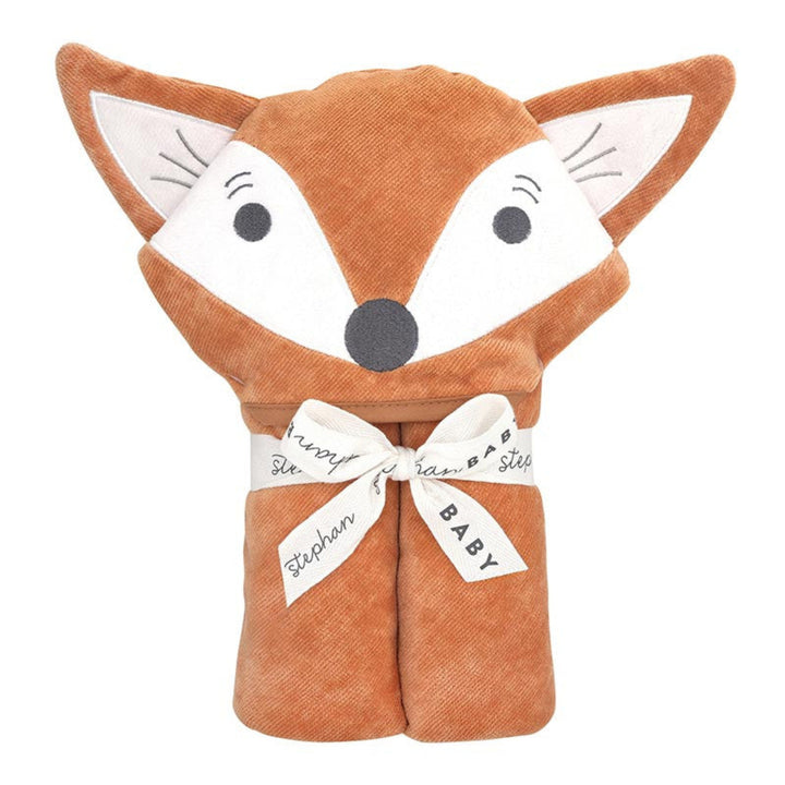A plush hooded baby blanket shaped like a fox head, in warm rust-brown and white fabric, tied with a white ribbon printed with names and the word BABY, on a plain white background.