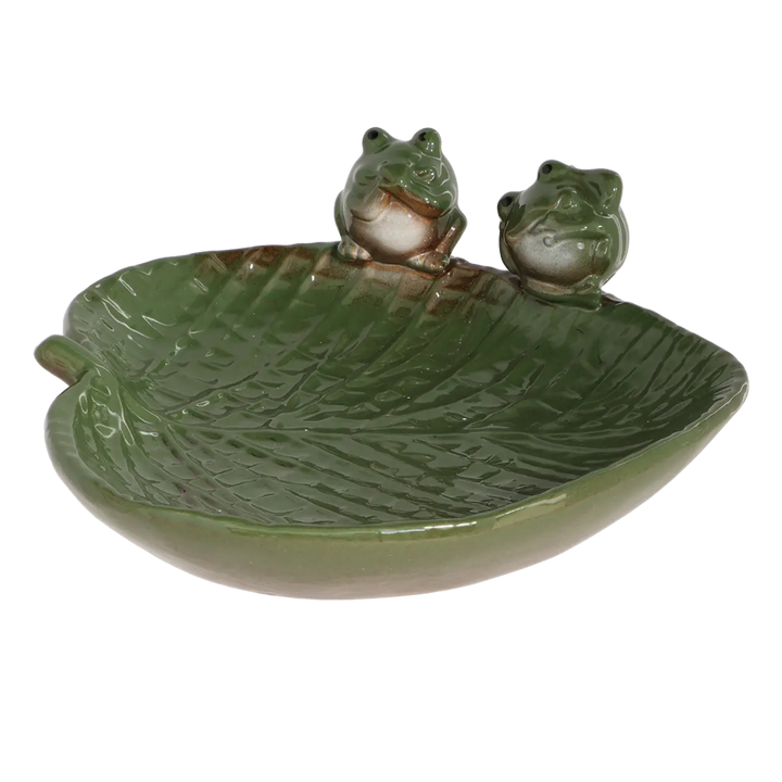 Ceramic leaf-shaped dish with frog designs on a white background