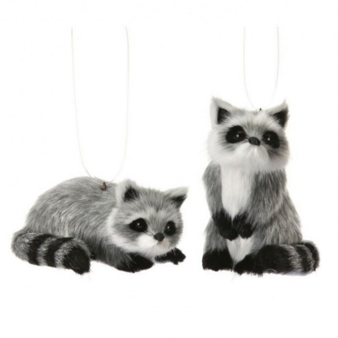 Two plush raccoons on a white background