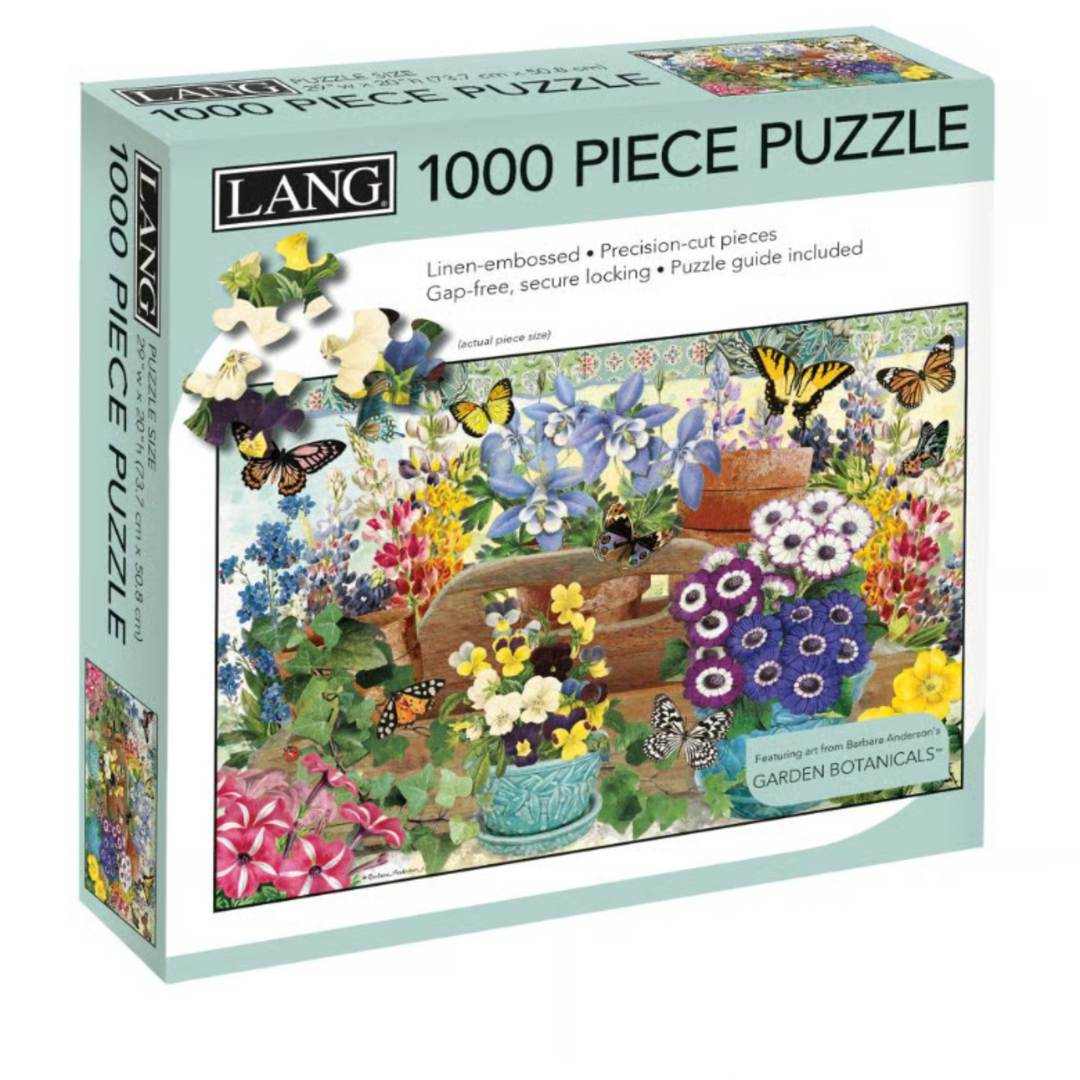 Lang 1000 Piece Puzzle box for 'Garden Botanicals', featuring a colorful illustration of a butterfly garden on the front and side panels.