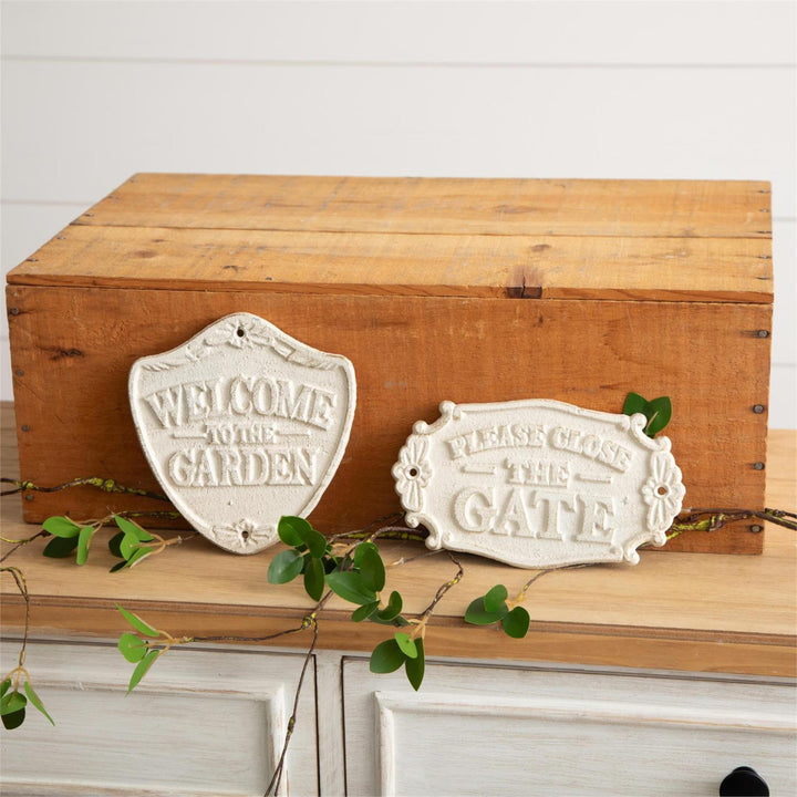 Wooden box with decorative signs 'Welcome to the Garden' and 'Please Close the Gate' on a white background.