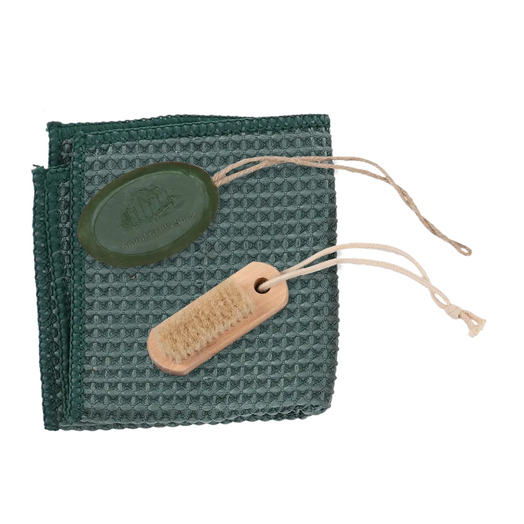 Green waffle-textured cloth with a wooden brush and a green label on a white background