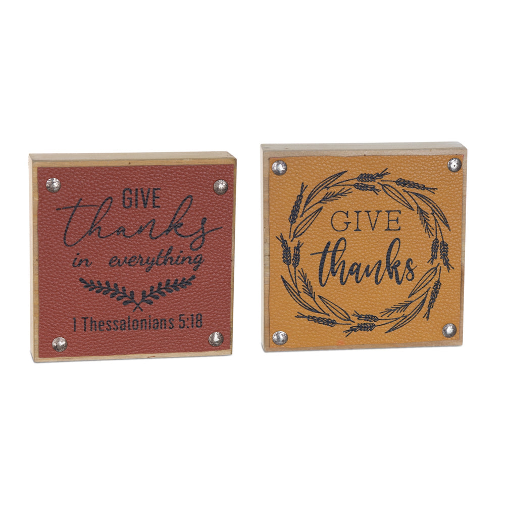 Two wooden blocks with 'Give thanks' text and wreath design on a white background