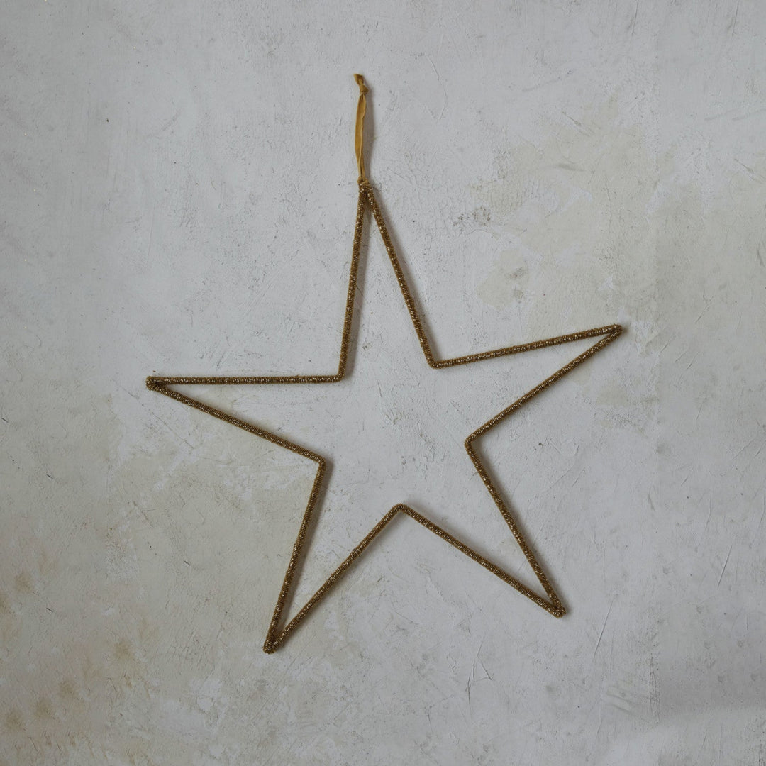 Star-shaped object made of thin metal on a textured surface