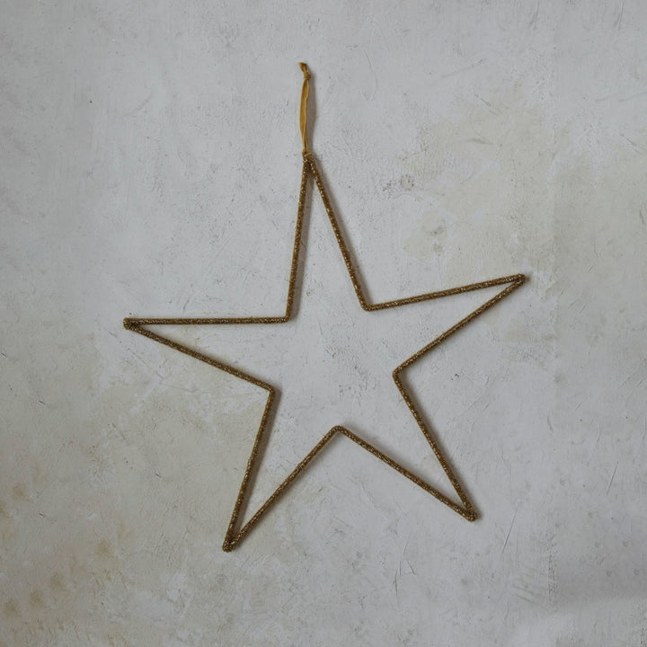 Star-shaped object made of thin metal on a textured surface