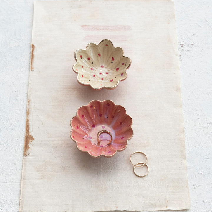 Two ceramic bowls with floral designs on a textured surface