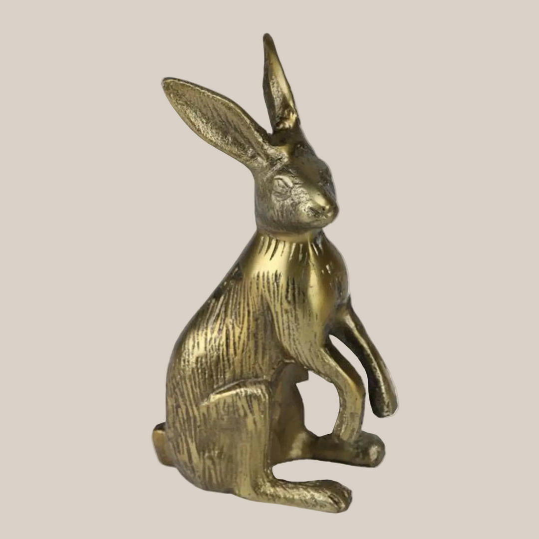 Bronze rabbit figurine on a white background