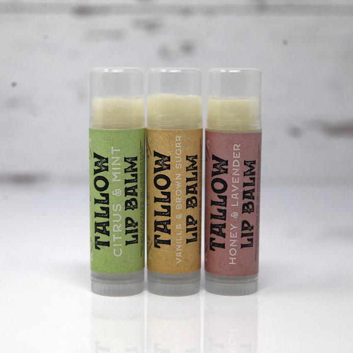 Three lip balm tubes with different scents on a white background