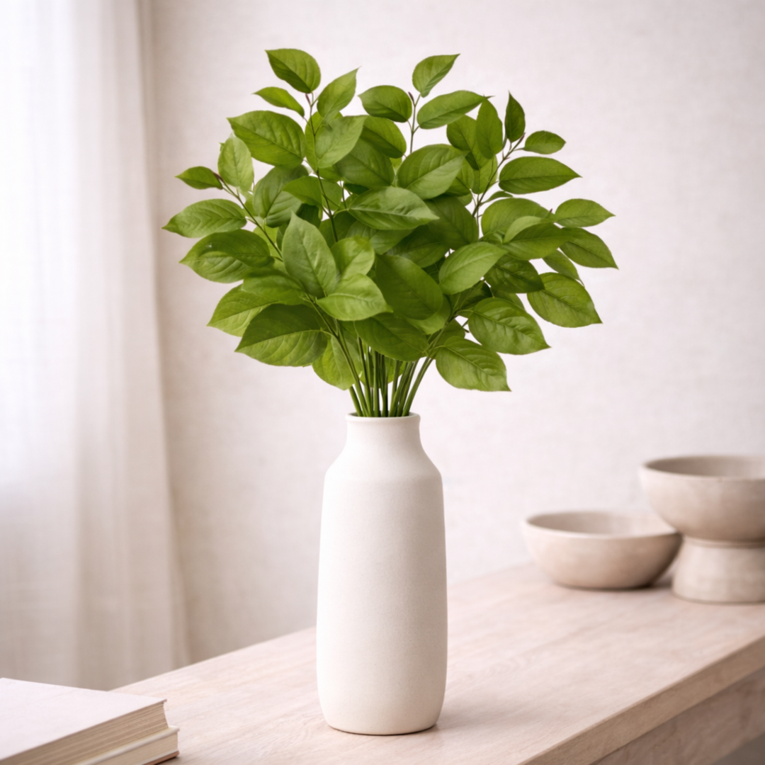 Salal Leaf Sprays in white vase with neutral background