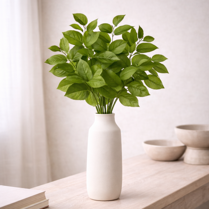 Salal Leaf Sprays in white vase with neutral background