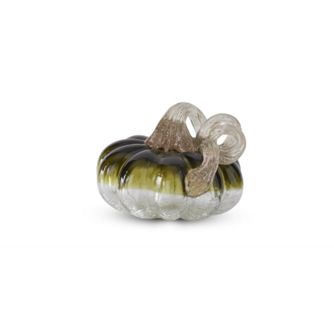 Glass pumpkin with ribbed texture and brown stem on a white background