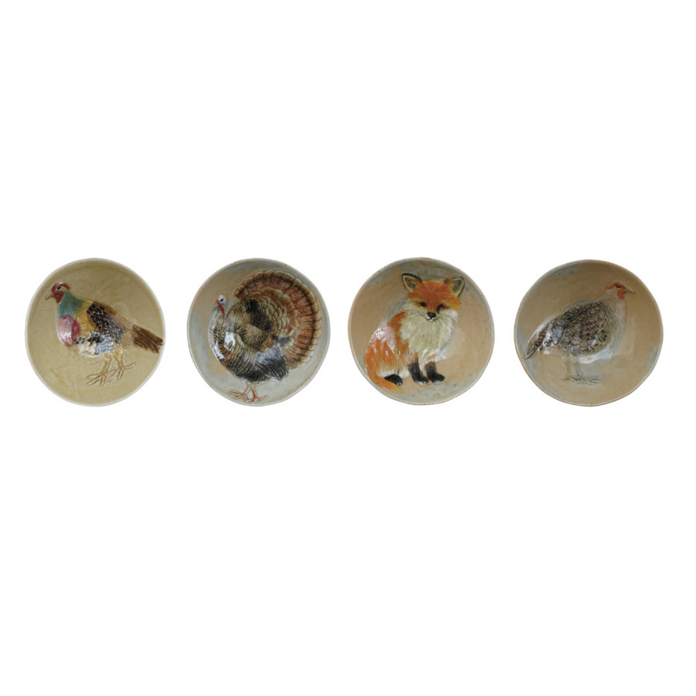Set of ceramic plates with animal illustrations on a white background