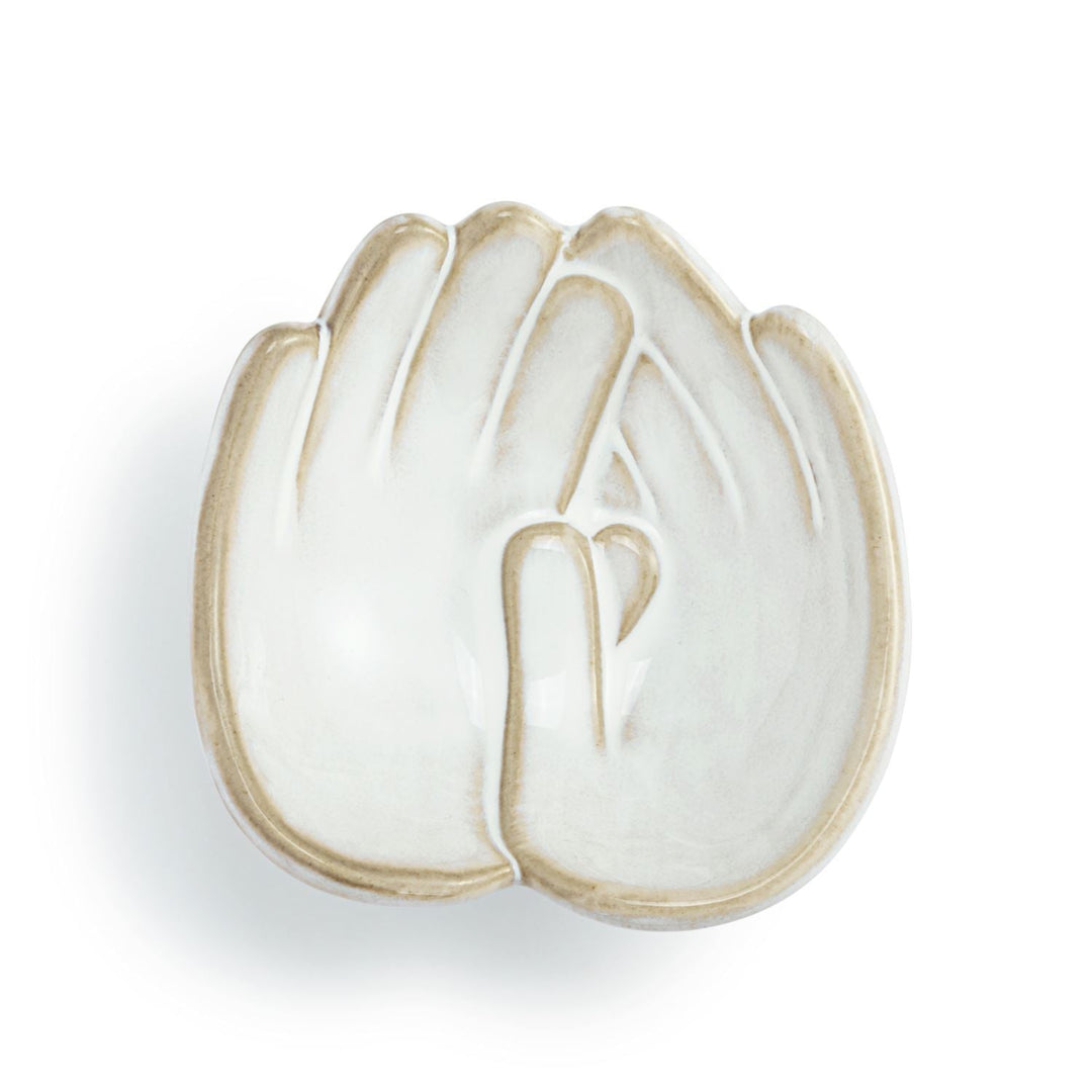 White ceramic dish with gold rim on a white background