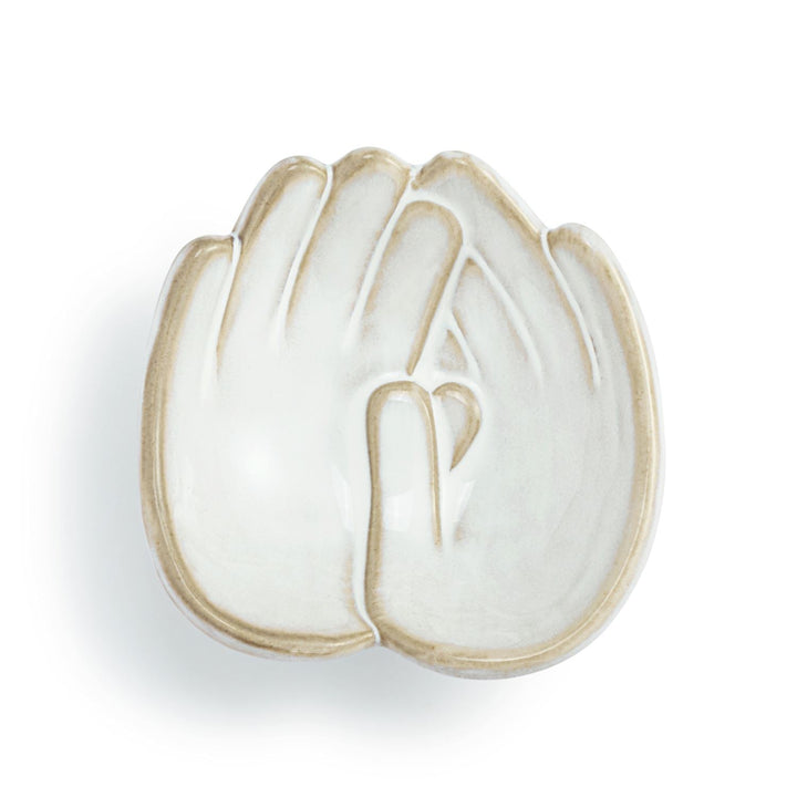 White ceramic dish with gold rim on a white background
