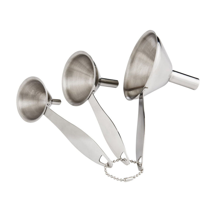 Set of three metal funnels on a white background