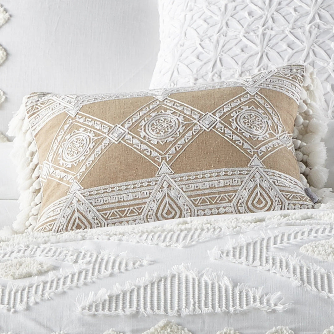 Decorative pillow with geometric pattern on a textured white surface