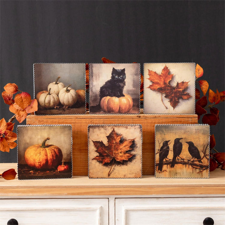 Set of decorative panels with autumn-themed images on a wooden stand.