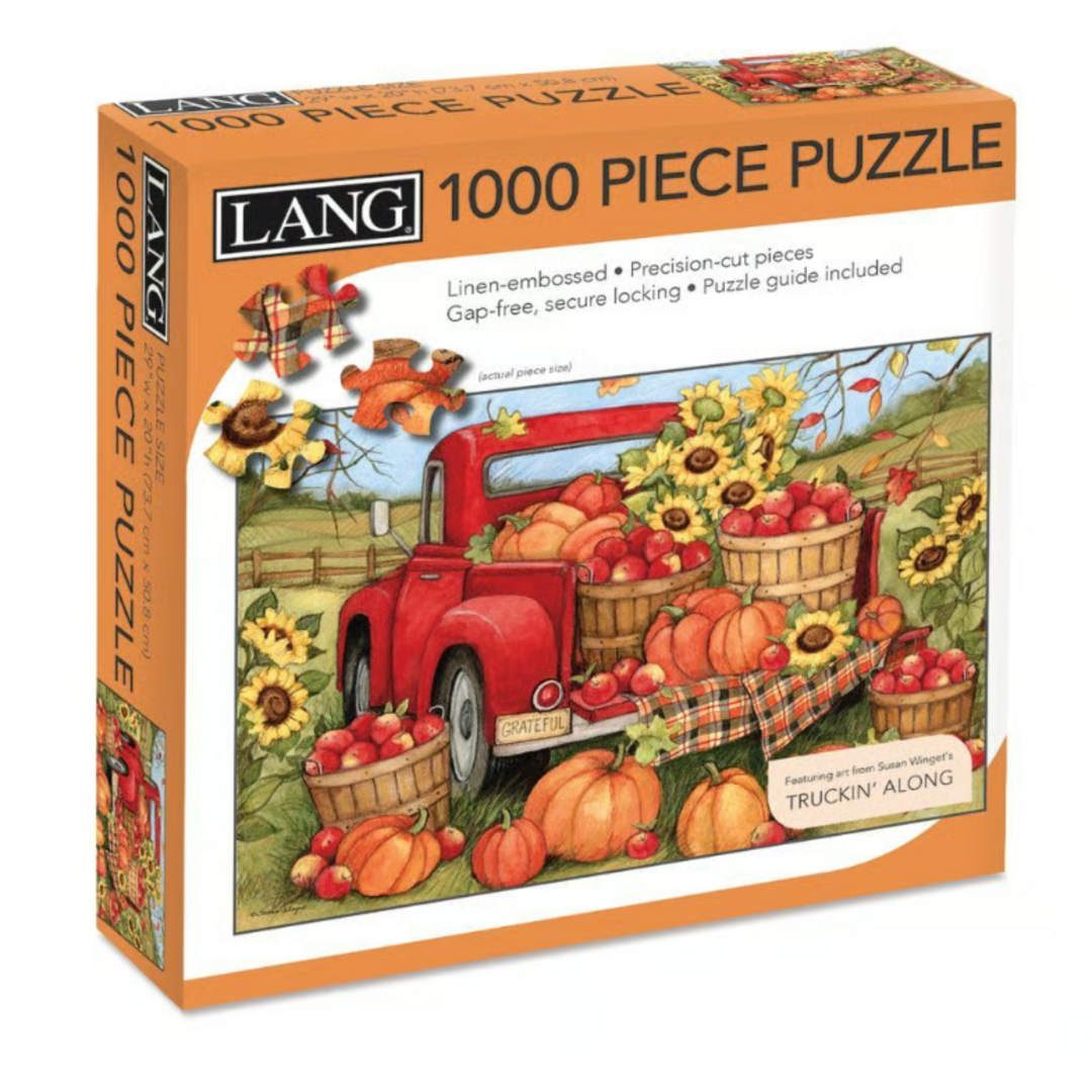 Lang 1000-piece jigsaw puzzle box featuring an autumn harvest scene with a red pickup truck loaded with pumpkins, apples, and sunflowers, shown on a white background.