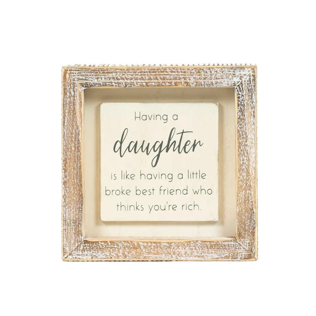 Decorative frame with a humorous quote about having a daughter on a white background
