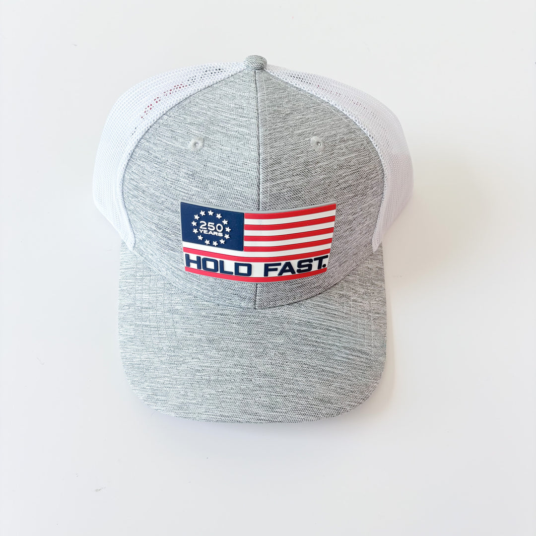 Gray and white cap with a flag design and 'Hold Fast' text on a white background