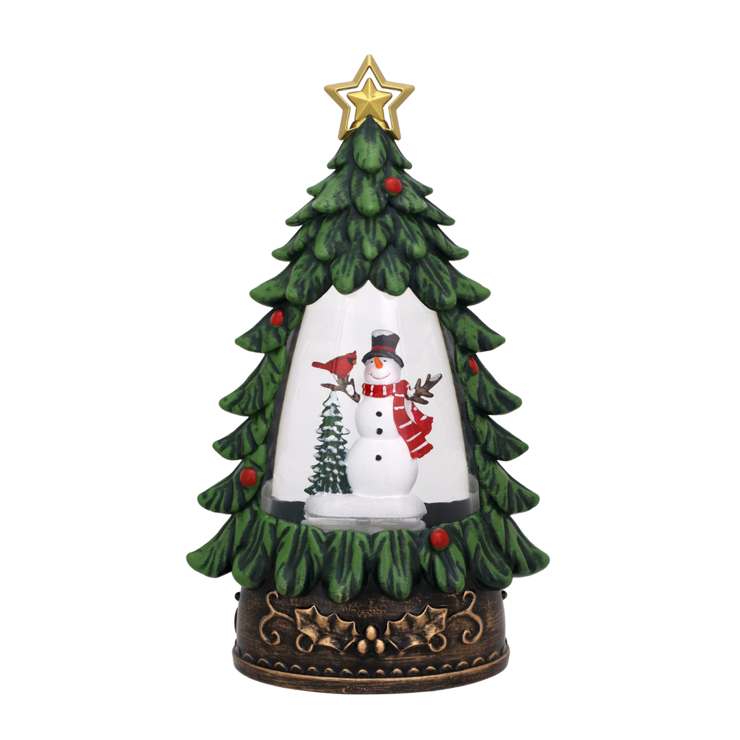 A decorative tabletop Christmas tree figurine with a green tiered tree shape, gold star topper, snowman scene inside a clear dome, and an ornate dark brown base.