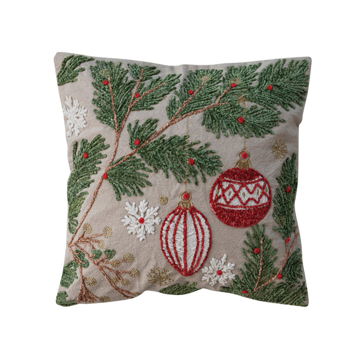Decorative pillow with Christmas-themed embroidery on a beige background