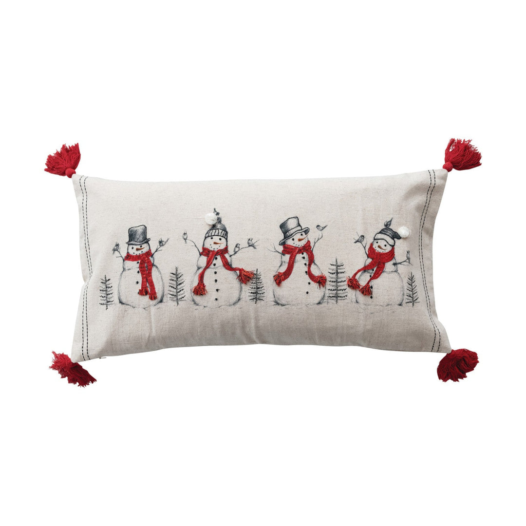 Decorative pillow with snowman design and red tassels on a white background