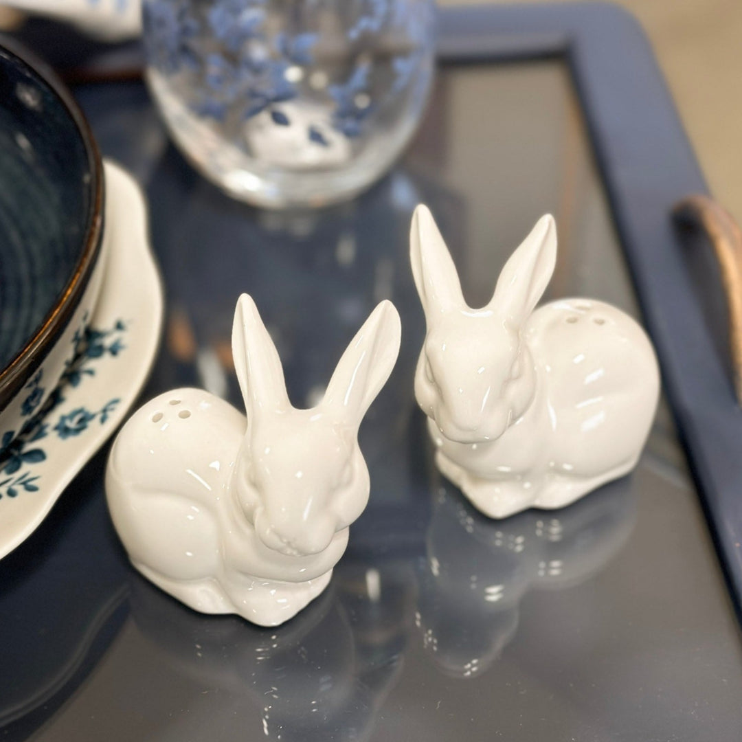 bunny salt & pepper shaker set on tray beside plates