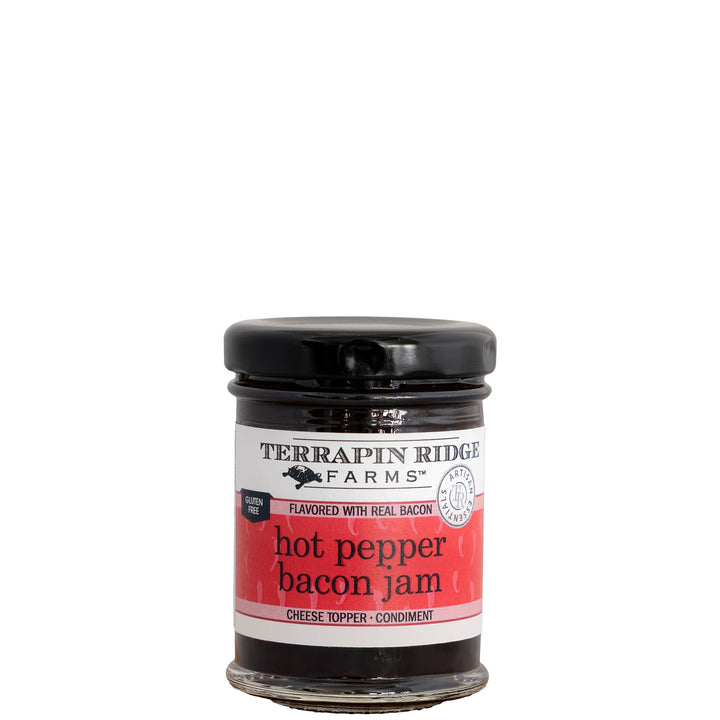 A glass jar of Terrapin Ridge Farms Hot Pepper Bacon Jam with a black lid and a red and white label, set against a plain white background.