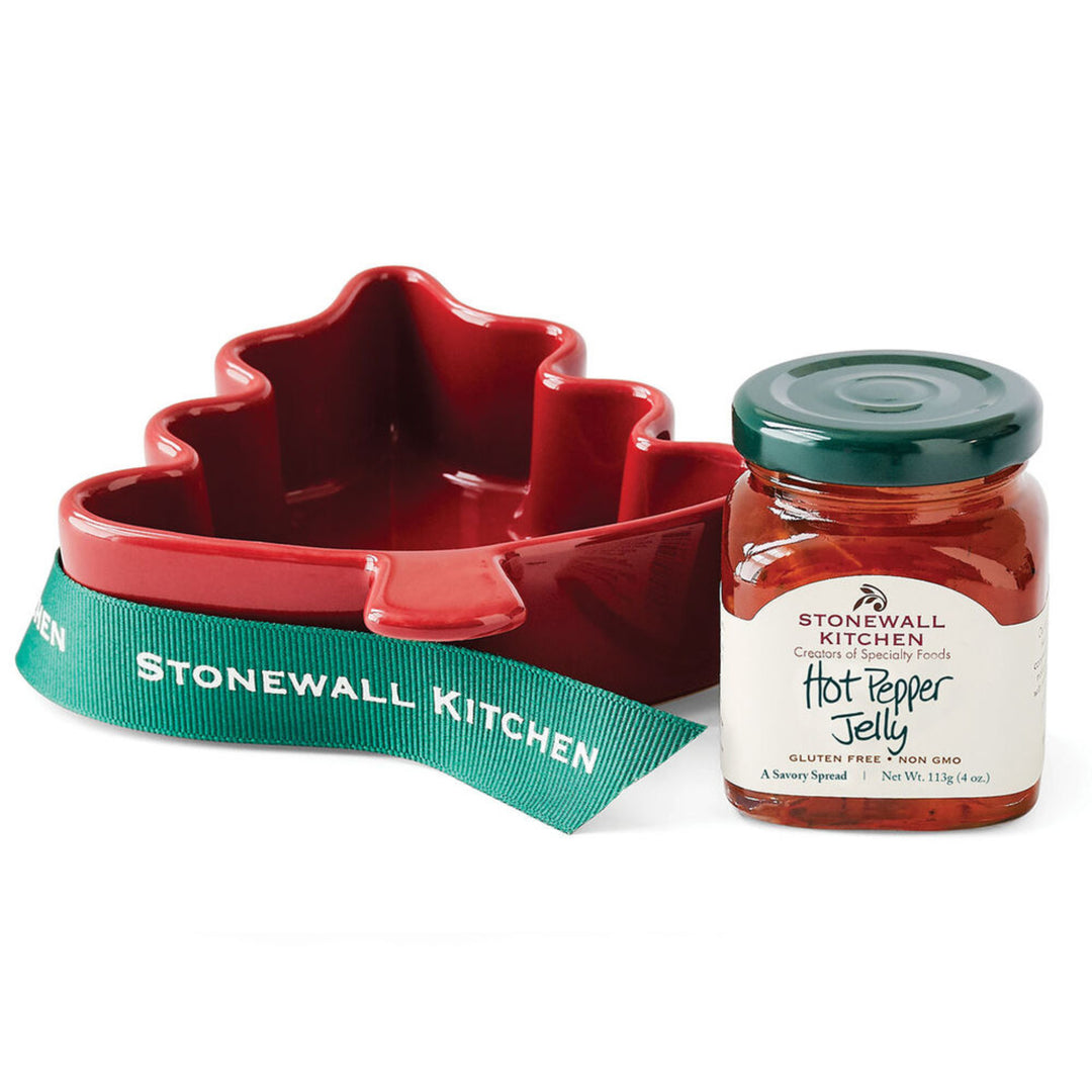 Red jelly mold with green ribbon and Stonewall Kitchen hot pepper jelly jar on a white background