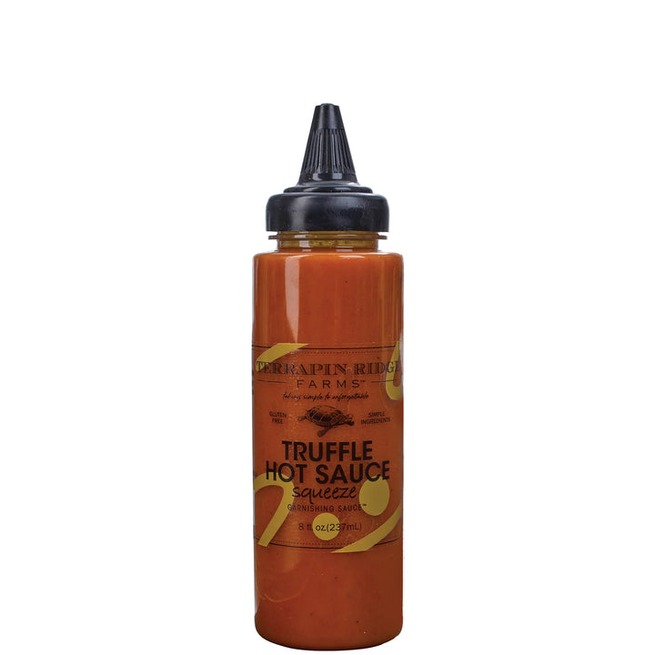 A squeeze bottle of Derkipapin Ridge Farms Truffle Hot Sauce on a plain white background.