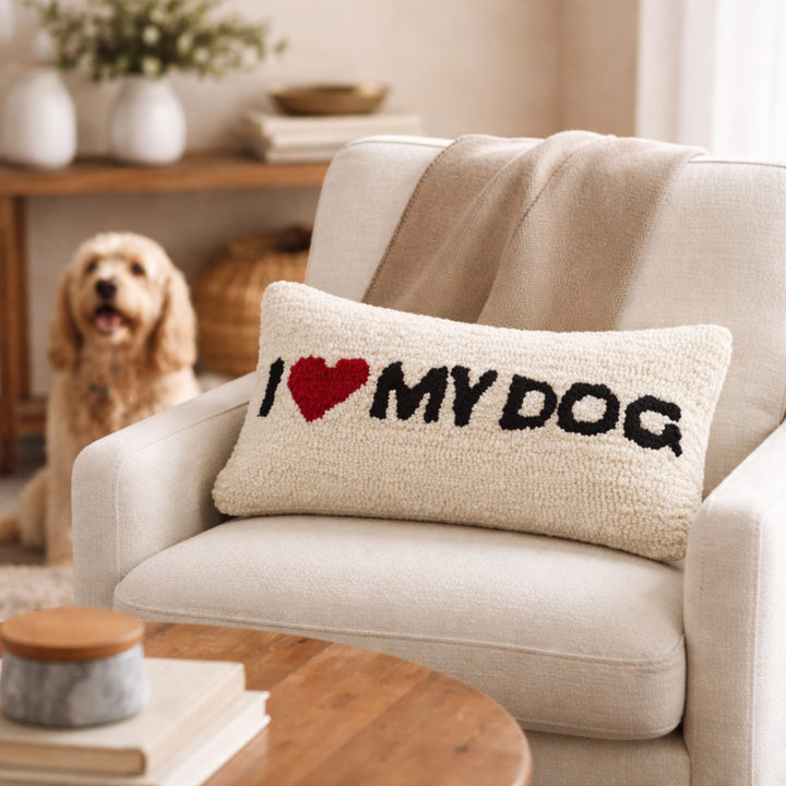 Decorative pillow with 'I ❤️ MY DOG' text on a couch in a living room.