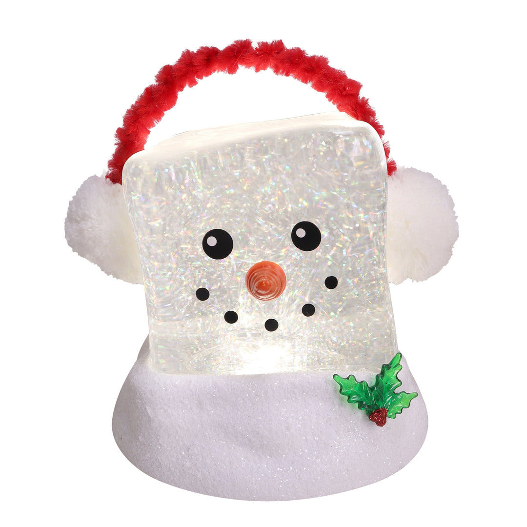A snowman-shaped Christmas light or ornament with a glittery white body, fluffy white ears, a red fuzzy handle, black facial features, a small orange nose, and a green holly accent on a white background.
