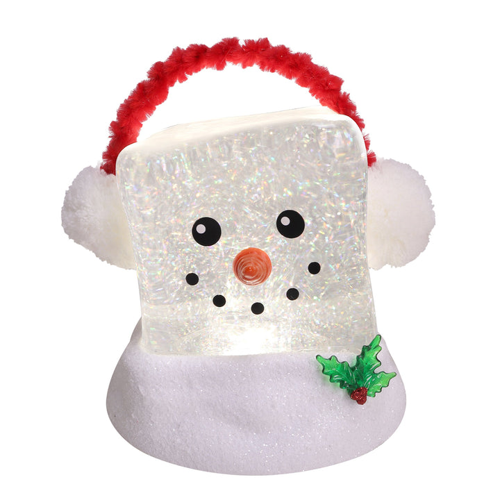 A snowman-shaped Christmas light or ornament with a glittery white body, fluffy white ears, a red fuzzy handle, black facial features, a small orange nose, and a green holly accent on a white background.