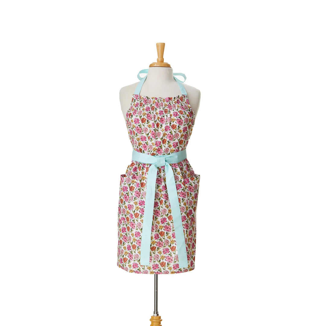 Floral apron with a light blue ribbon on a mannequin against a white background