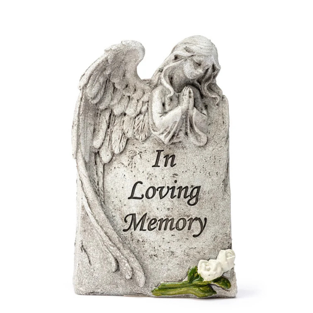 Memorial stone with angel sculpture and 'In Loving Memory' text on a white background