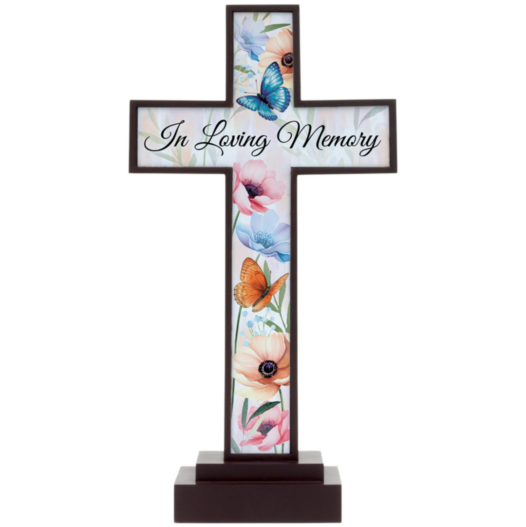 Decorative cross with floral and butterfly design and 'In Loving Memory' text on a white background
