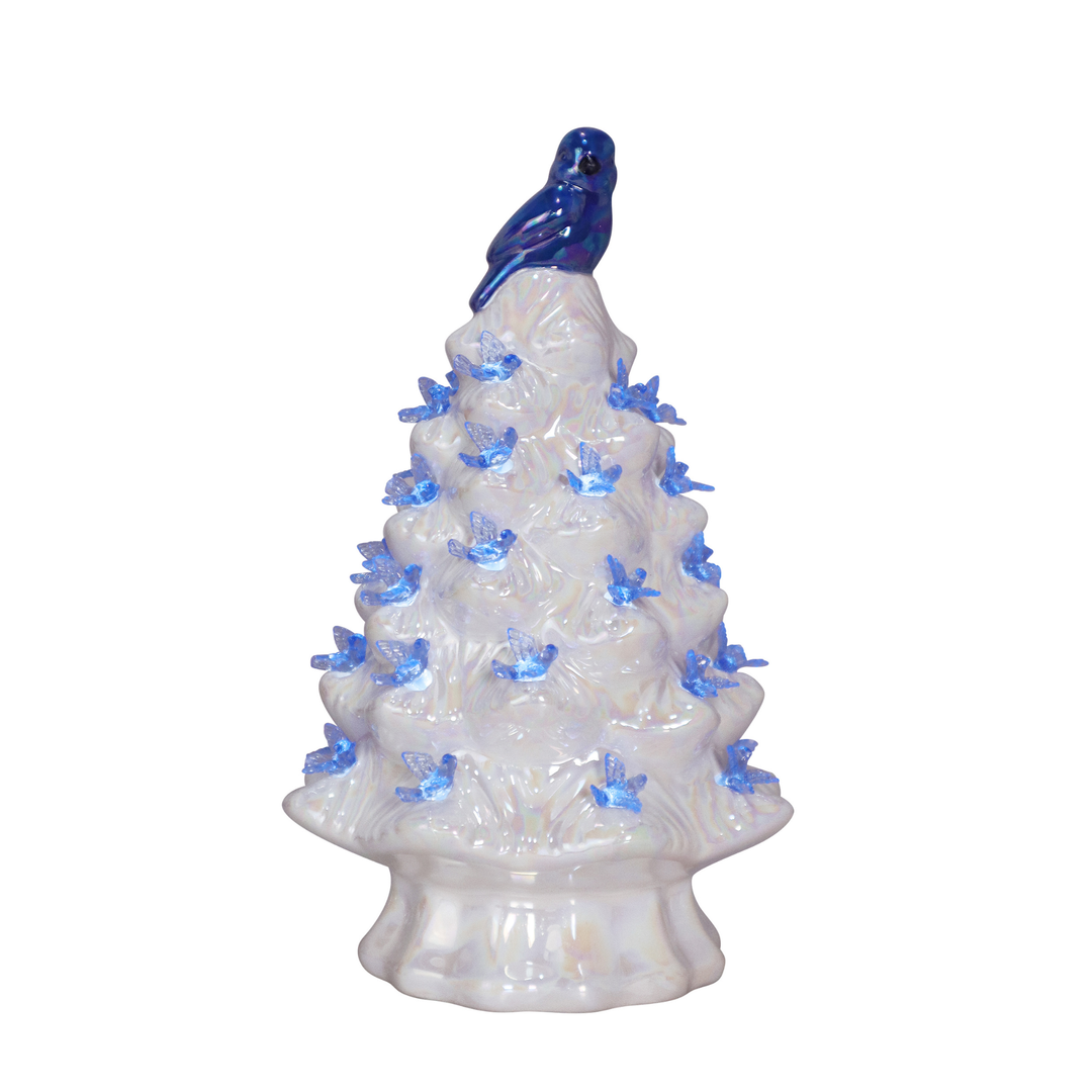 Decorative ceramic Christmas tree with blue lights and a blue bird on top against a white background