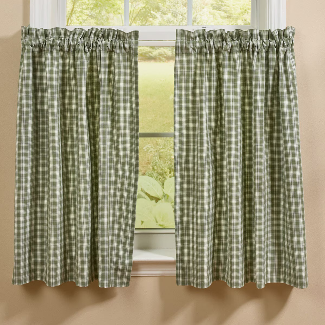 Green and white checkered curtains hanging in front of a window.