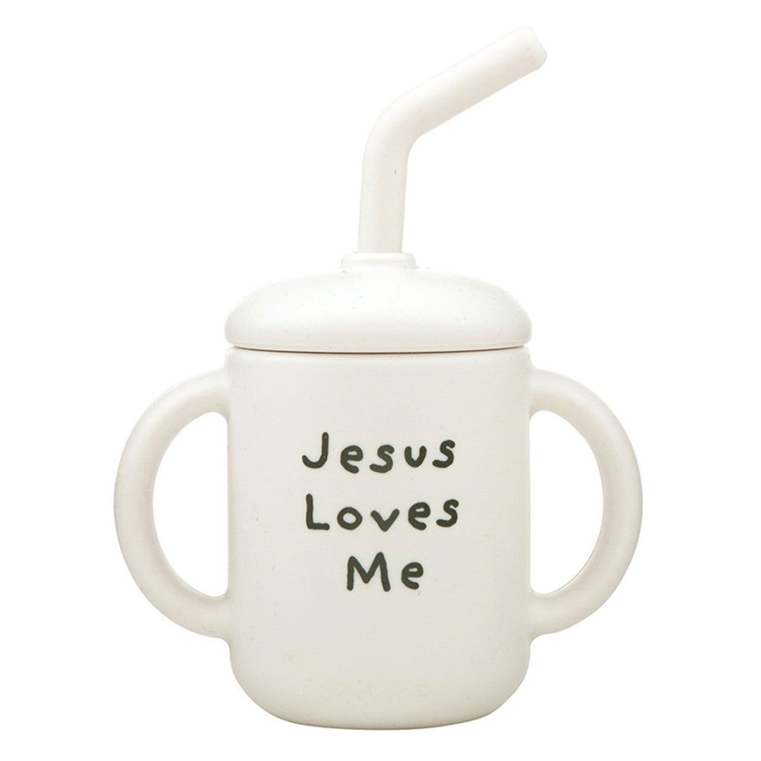 White sippy cup with 'Jesus Loves Me' text on a white background
