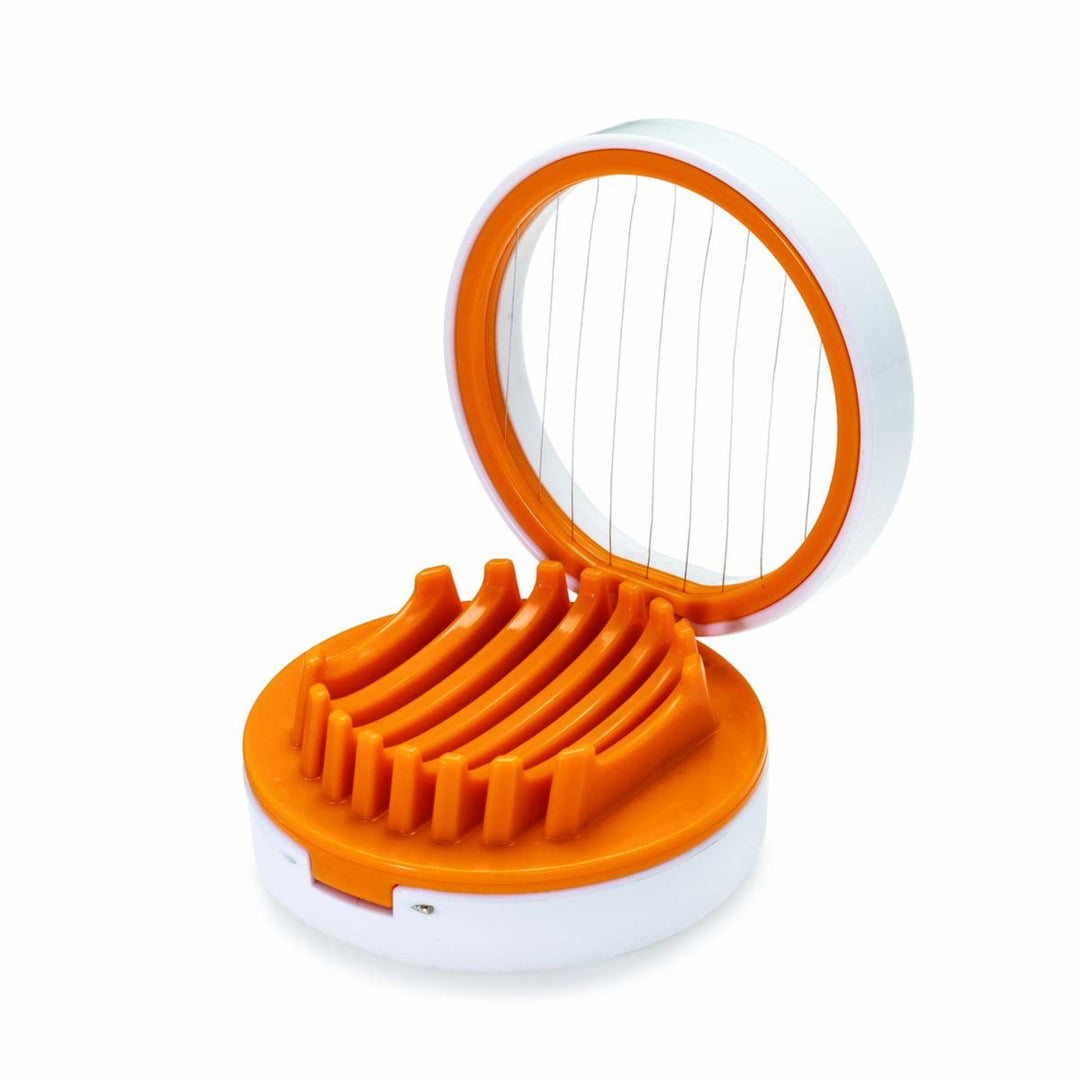 An electric egg slicer with a white plastic body and bright orange accents, shown open with the wire slicing grid visible in the lid and the slots for eggs in the base, on a white background.