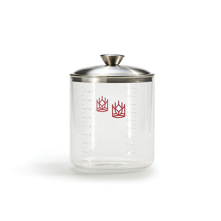 Clear glass jar with silver lid on a white background