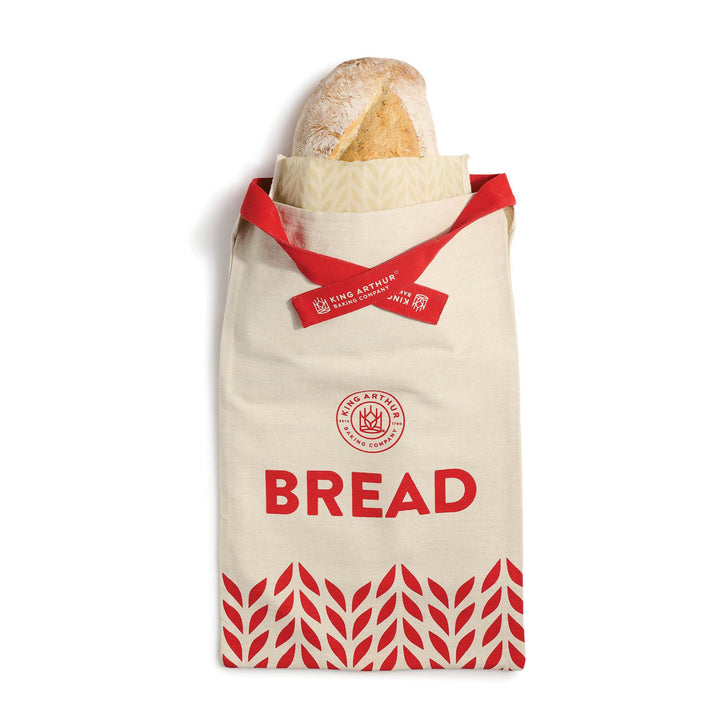 Bread bag with a loaf of bread inside on a white background