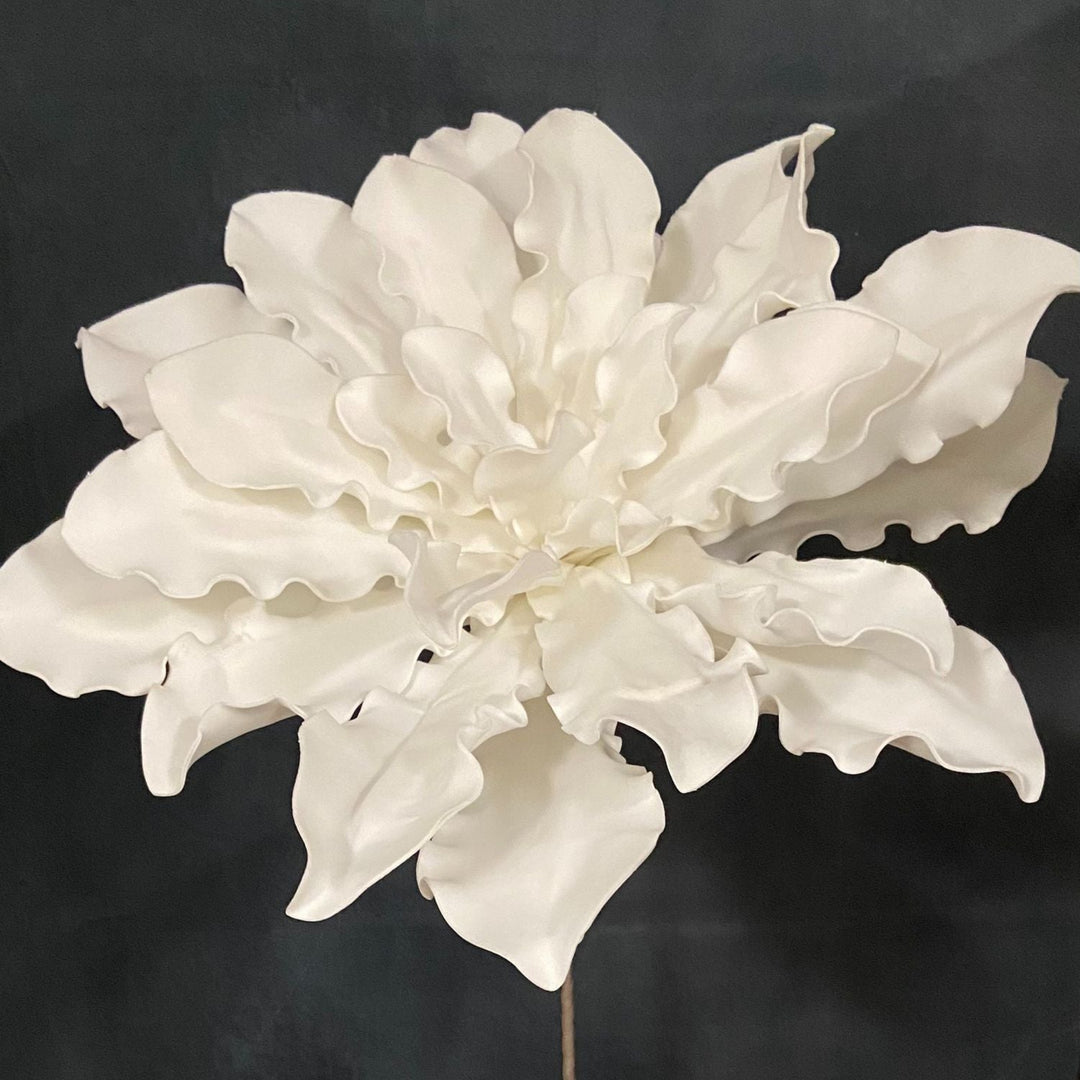 White artificial flower on a black background